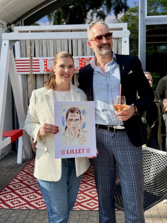 Illustrator Felix Scholz mit einer Dame die eine Portraitzeichnung in der Hand hält