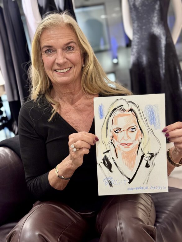 Dame beim AKRIS Dinner in Hamburg, in den Händen eine Portraitzeichnung von ihr von Felix Scholz Illustration
