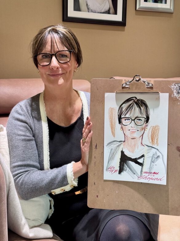 Felix Scholz_Live Event Illustration_Chopard Berlin Kurfürstendamm_3 Eine Dame mit Brille hält eine farbige Portraitzeichnung des Berliner Künstlers Felix Scholz